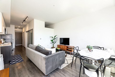 a living room with a couch and a table with chairs